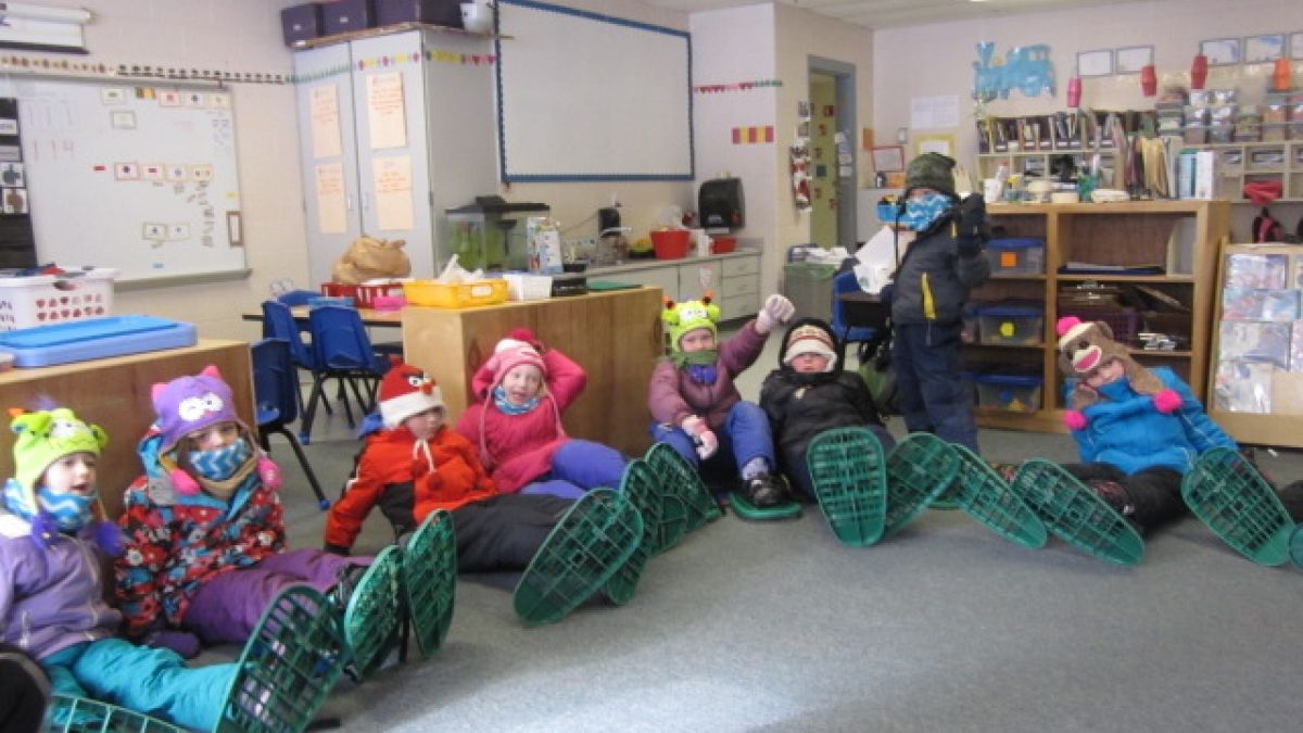 Ottauquechee students getting snowshoes on.