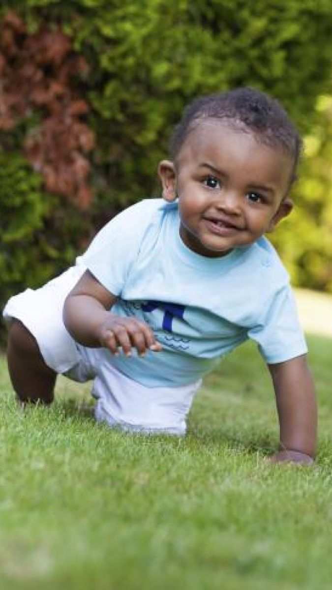 smiling small boy on grass
