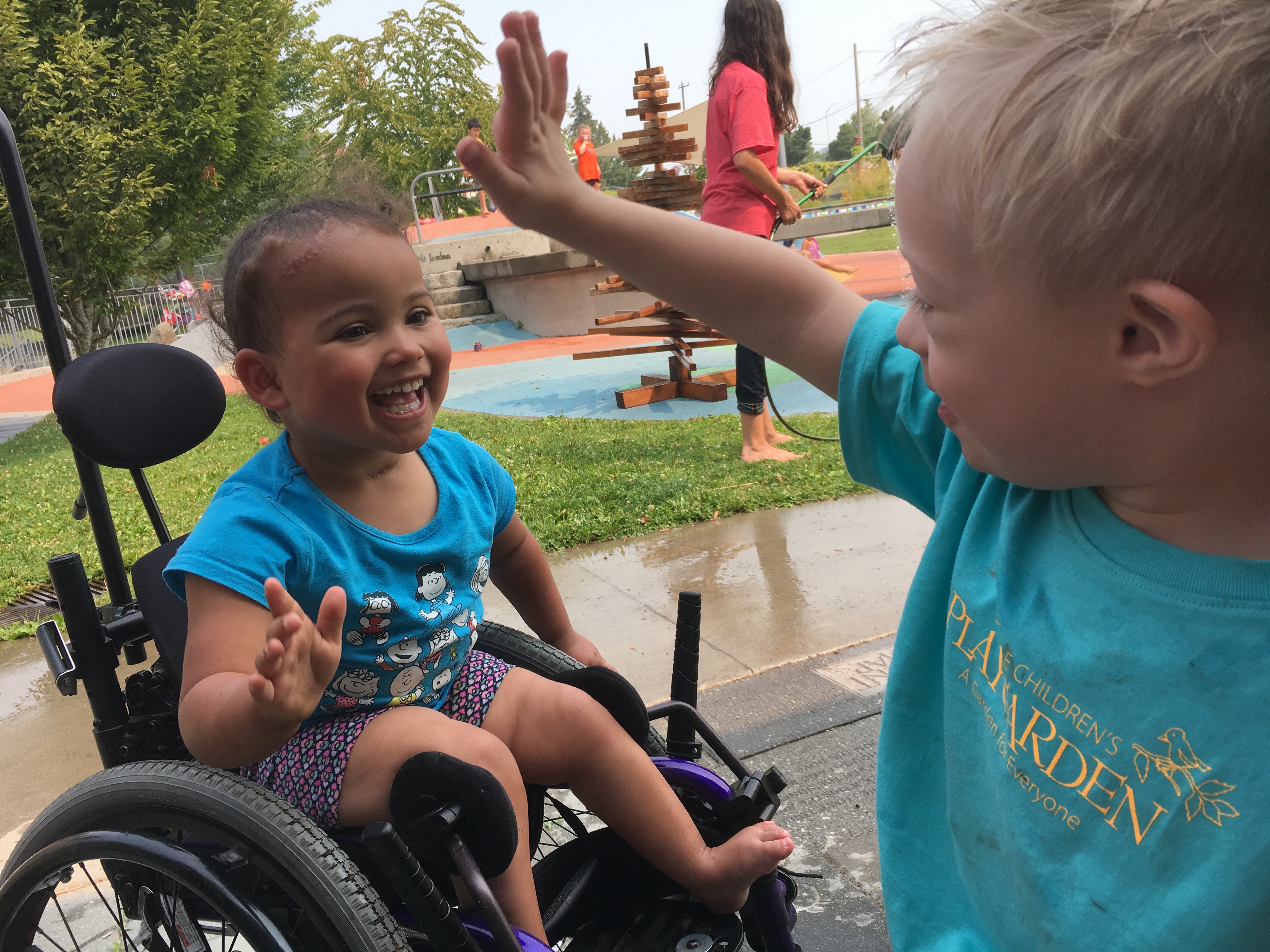 Two young, happy children going in for a high-five