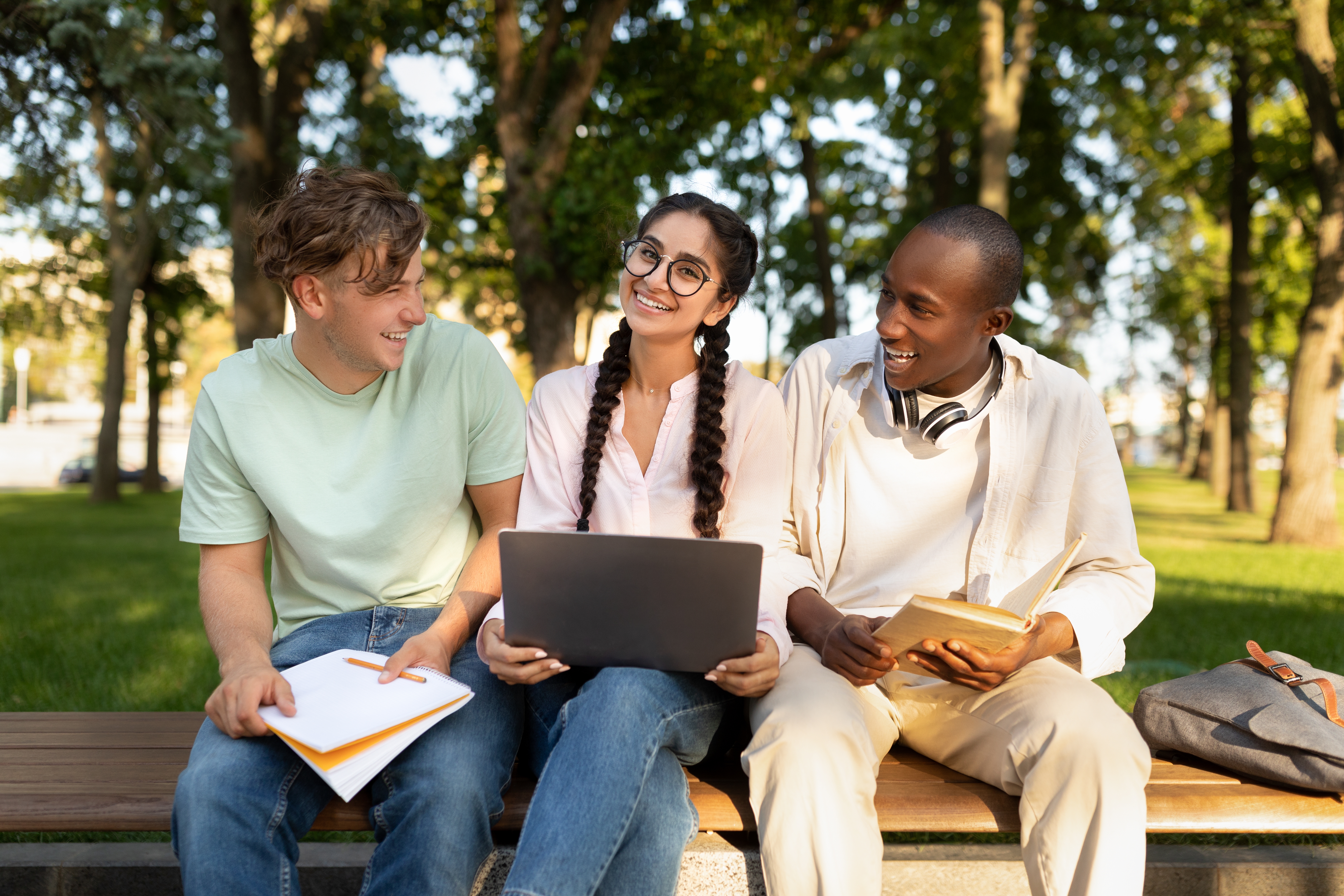 graduate students sitting on bench outside
