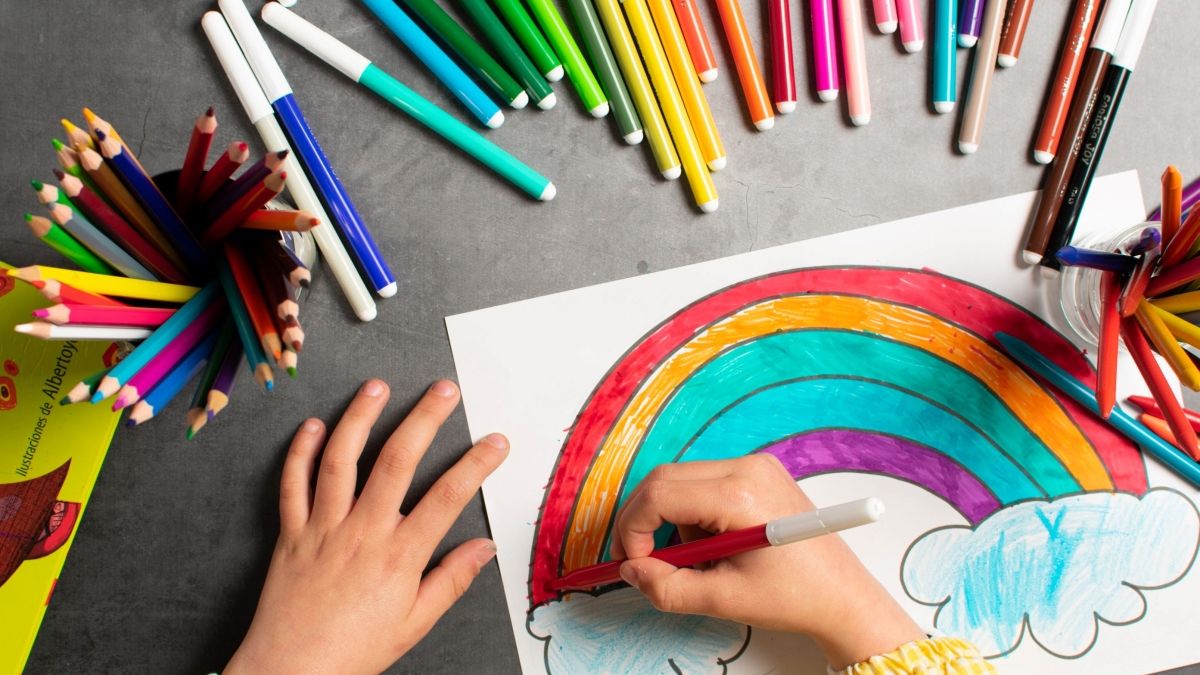child drawing rainbow