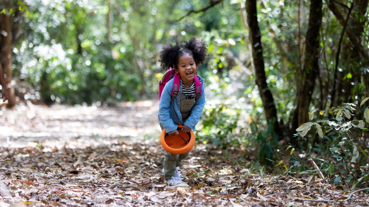 happy child hiking in woods