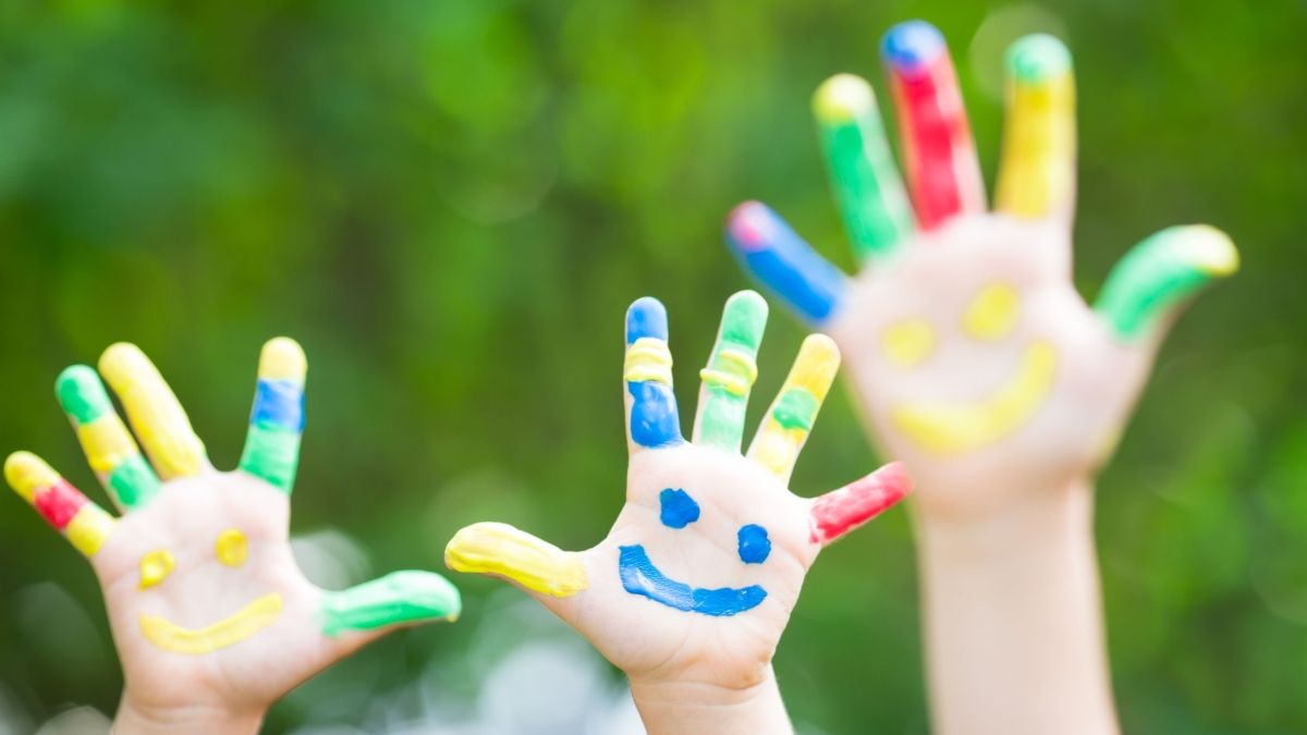 smiley faces painted on hands