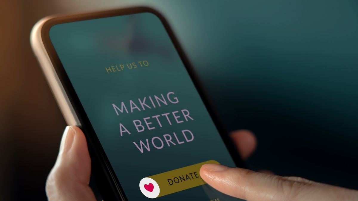 phone screen that reads "Help Us to making a better world: donate"