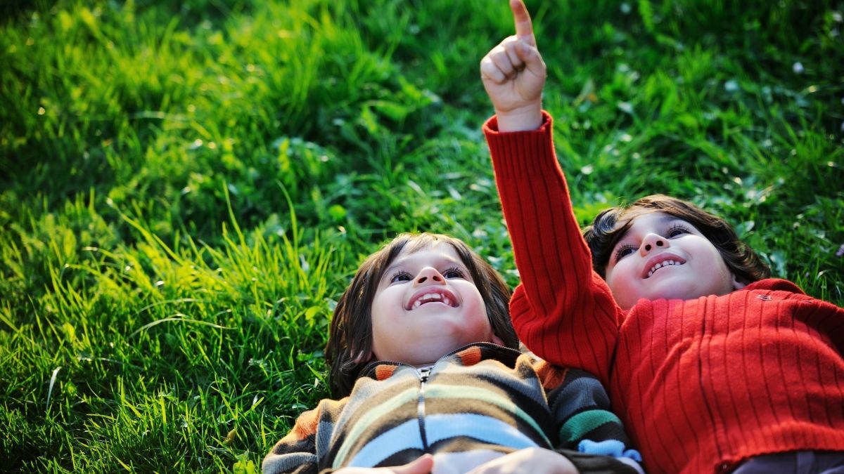 Children laying in grass