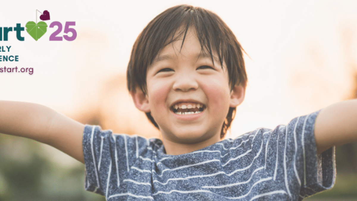 happy young boy smiling with arms wide open