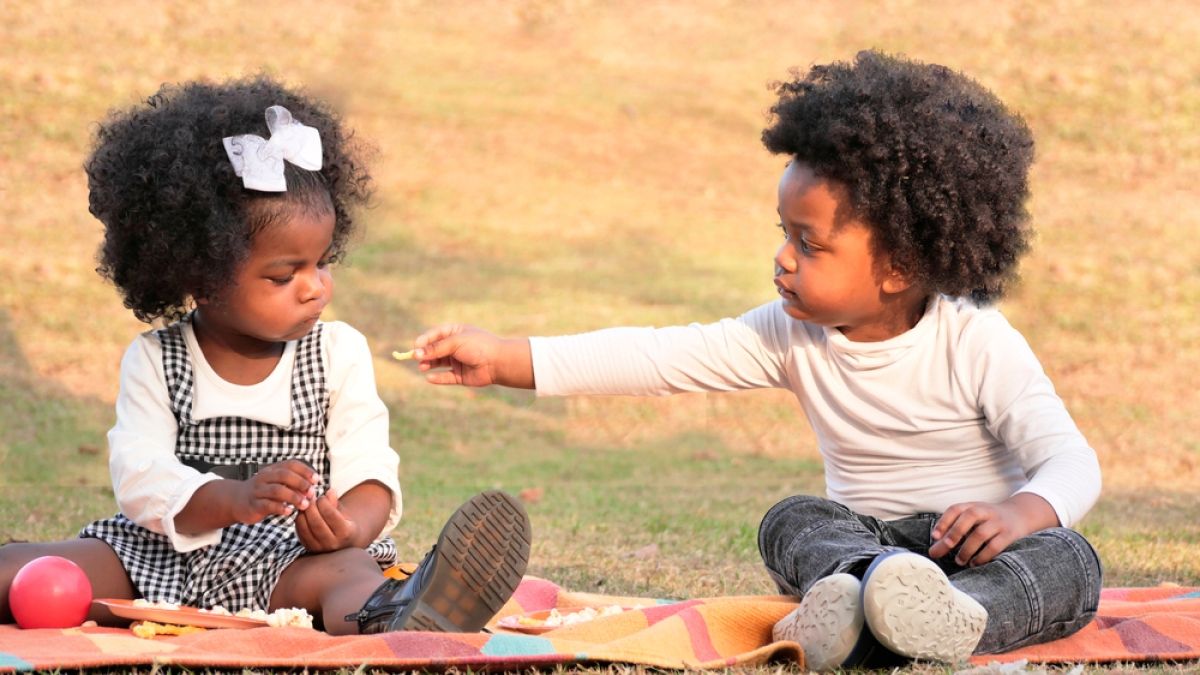 Children sharing at picnic