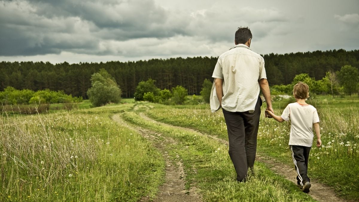 Father and son walking in nature reserve