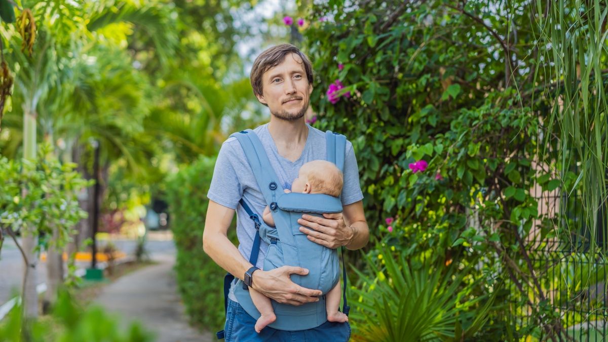 father walking in nature with baby son
