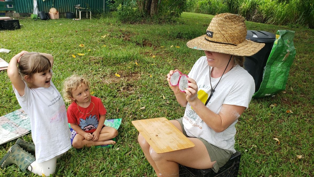 teacher opening fruit for children to see