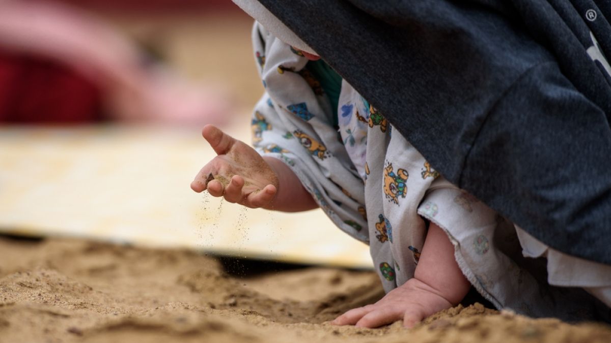 Child's palm and sand