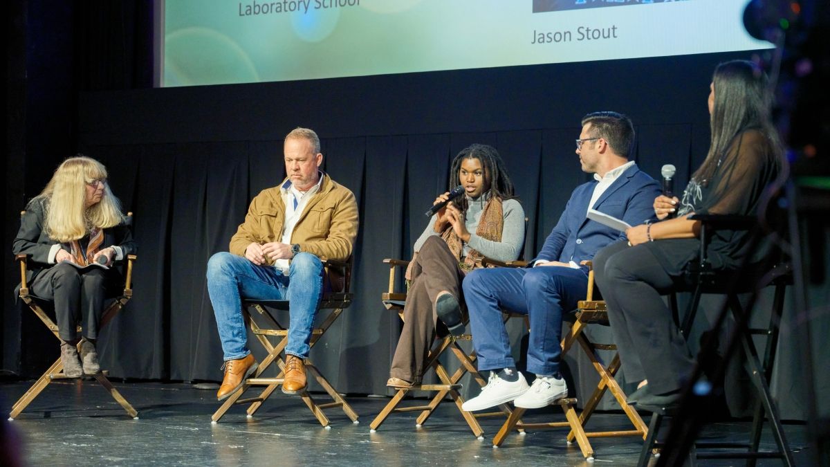 Sydney Gary speaking on stage as part of a panel discussion at the In Our Nature movie screening