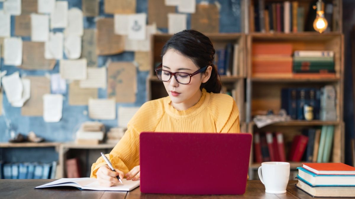 young woman at desk on laptop