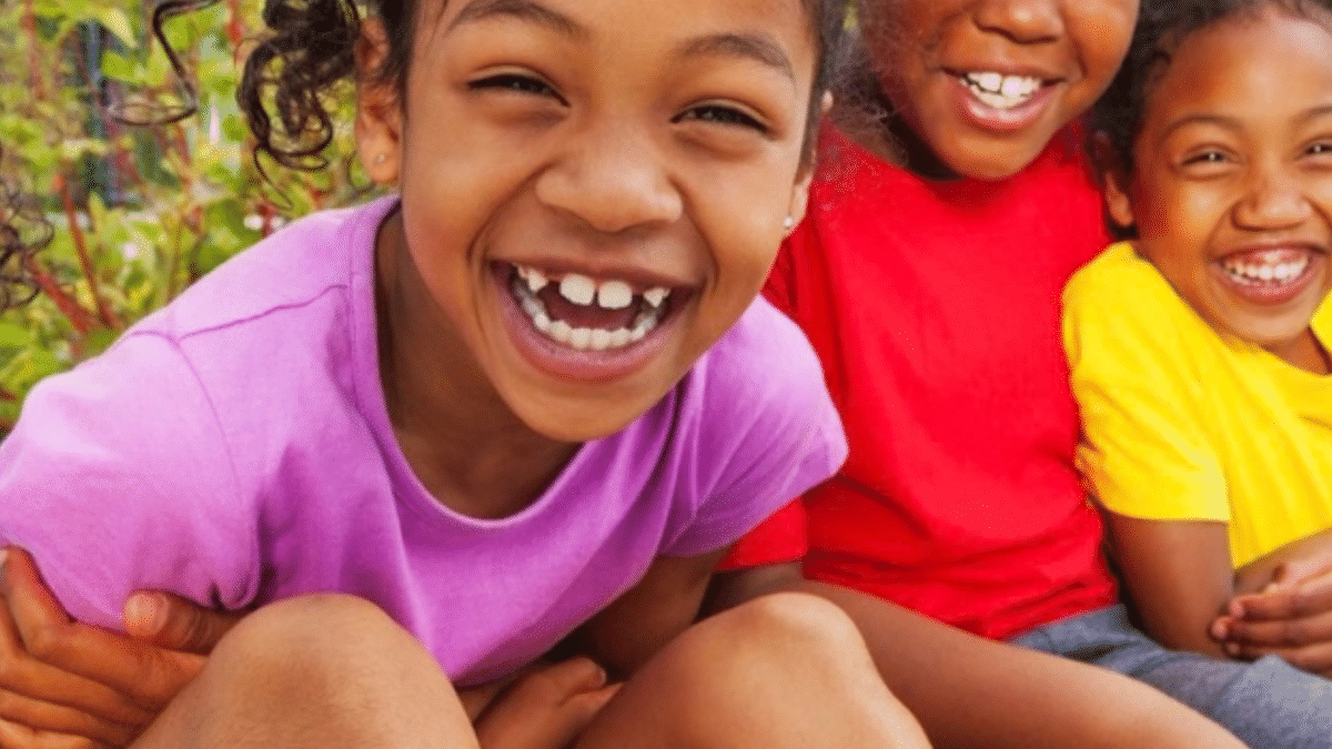children smiling into the camera