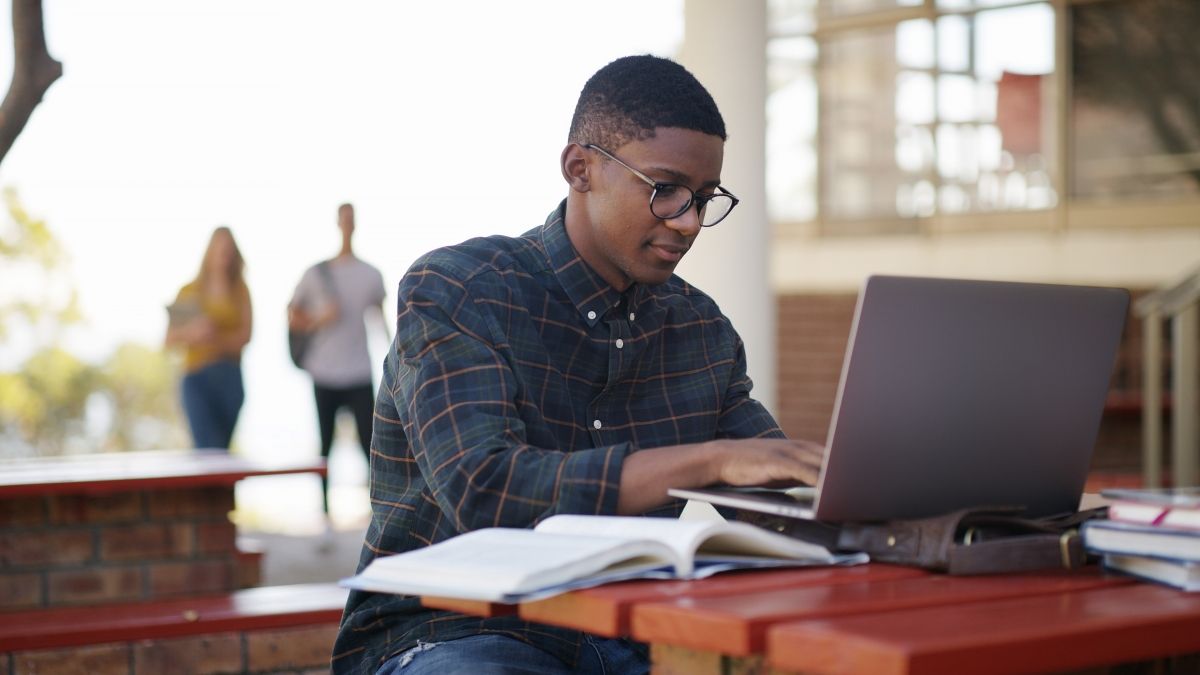 Student, typing and man in campus with laptop