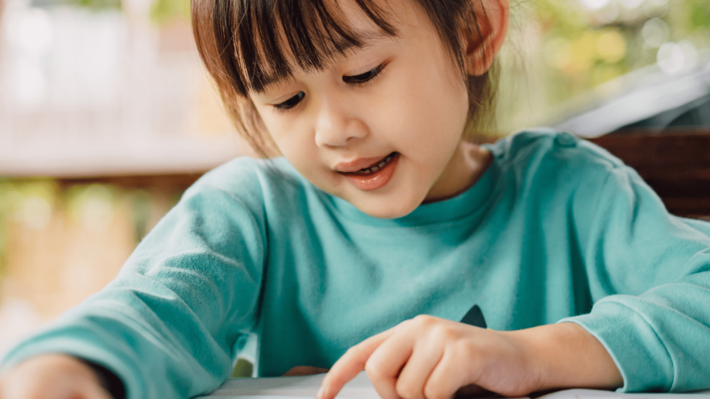 young child reading book