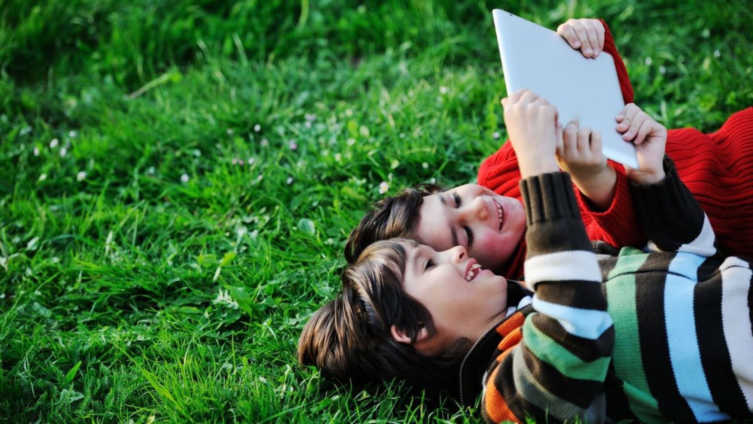 children reading on grass