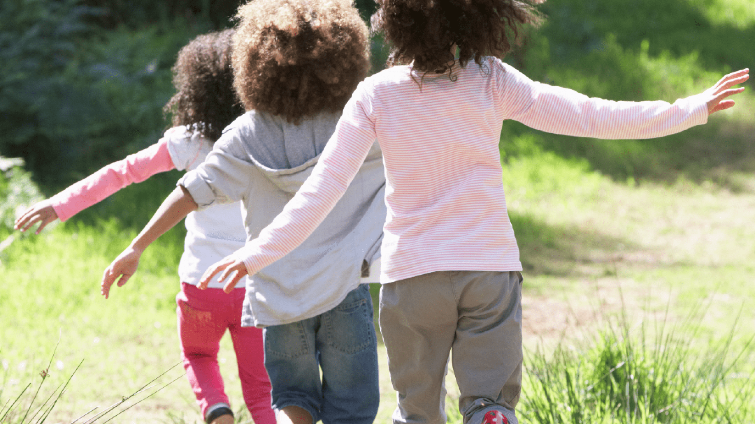 3 children running in a row outside