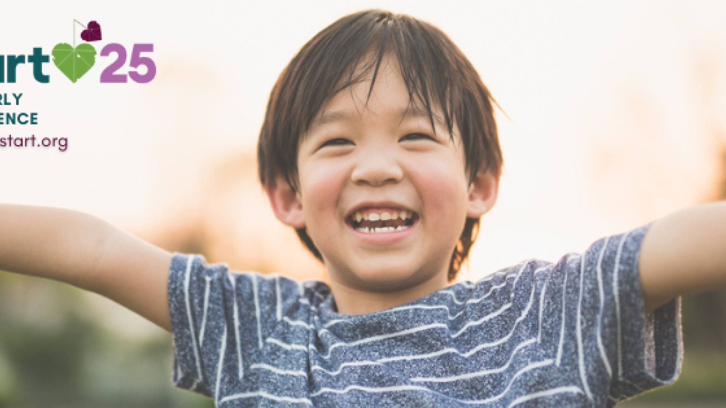 happy young boy smiling with arms wide open