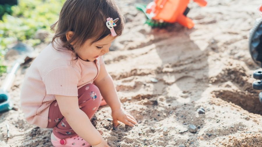 child playing in sand