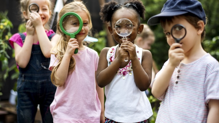 children looking through magnifying glasses