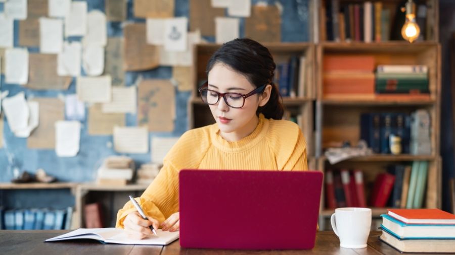 young woman at desk on laptop