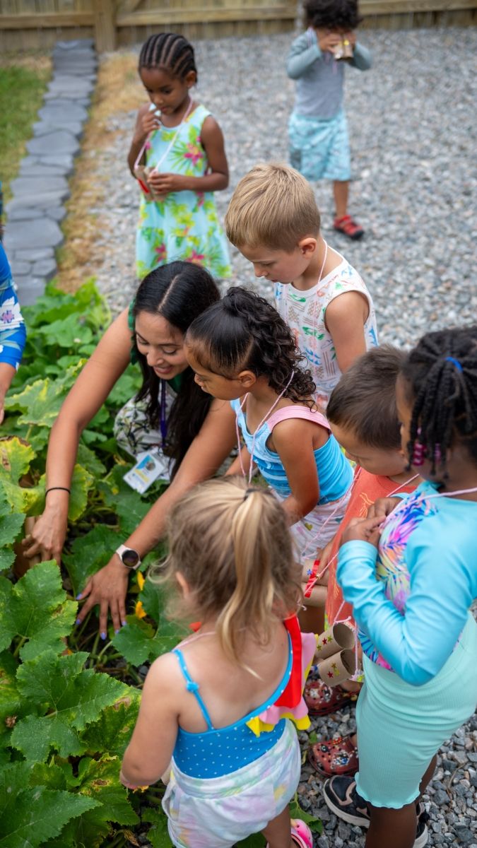 Teacher and students looking at garden