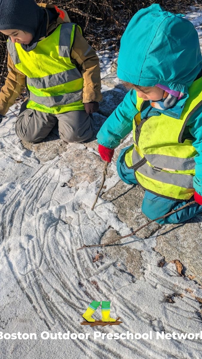 children writing in the snow with sticks