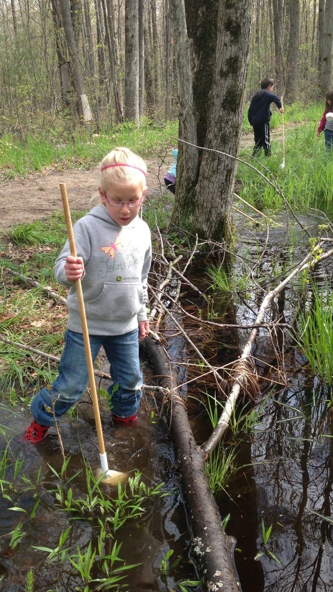 Children spend time outdoors daily, including searching for frogs in spring.