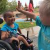 Two young, happy children going in for a high-five