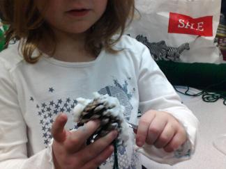 A Primary Photo Journalist records her partner's work during an activity to create bird feeders for the school yard.