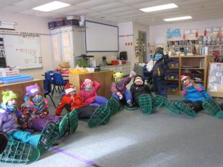 Ottauquechee students getting snowshoes on. 