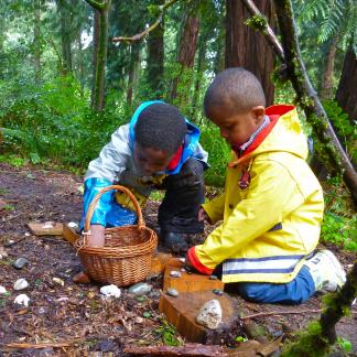 Students share items gathered in their forest classroom.