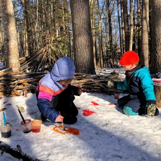 Juniper Hill preschoolers painting hearts in the snow.