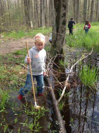 Children spend time outdoors daily, including searching for frogs in spring.