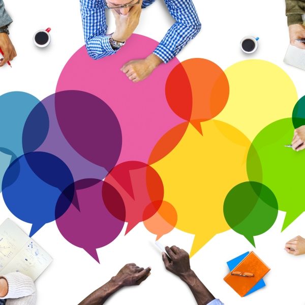 colorful thought bubbles with people at a conference table