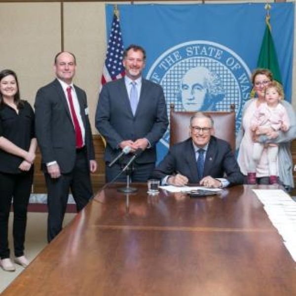 Senator Ranker and Governor Jay Inslee signing WA state signing licensing outdoor preschools