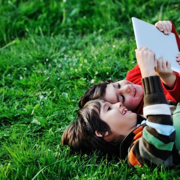 children reading on grass