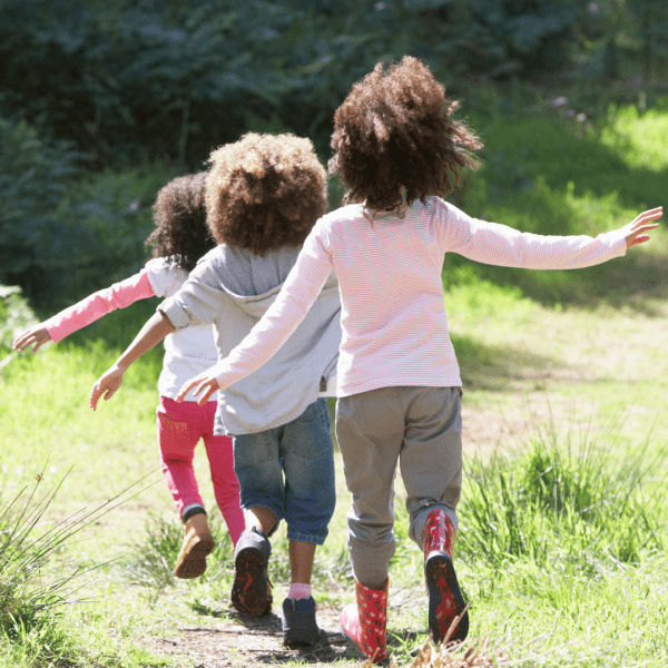 3 children running in a row outside