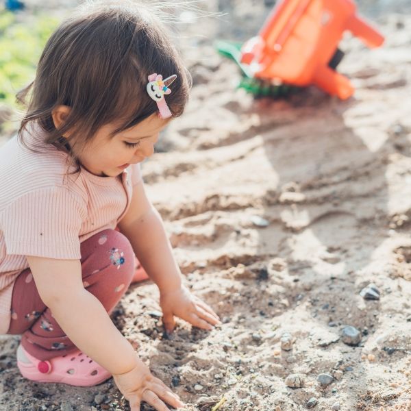 child playing in sand