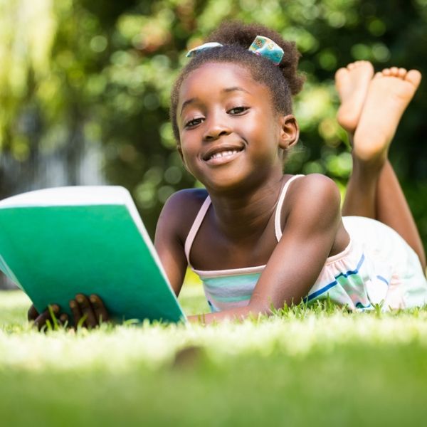young black girl reading outside