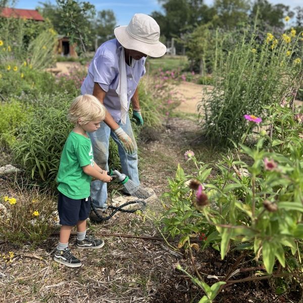 child gardening with adult
