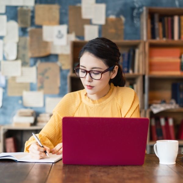 young woman at desk on laptop