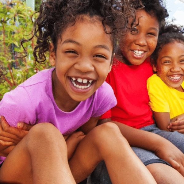 children smiling into the camera